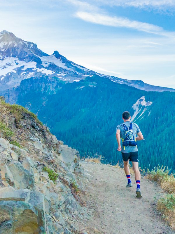 A man running on a mountain ridge
